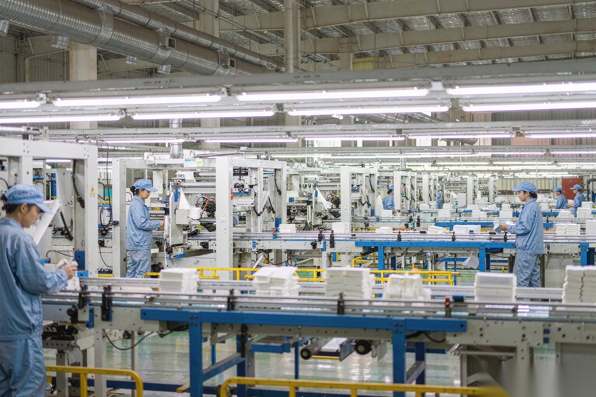 Jinman Paper Supplies workers operating napkin converting machines